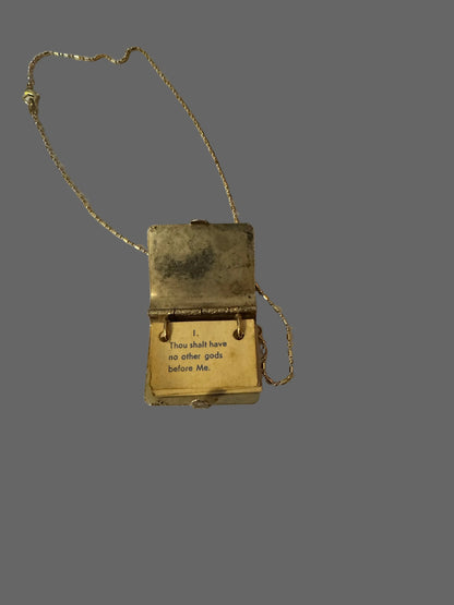 Vintage gold locket with chain on a white surface